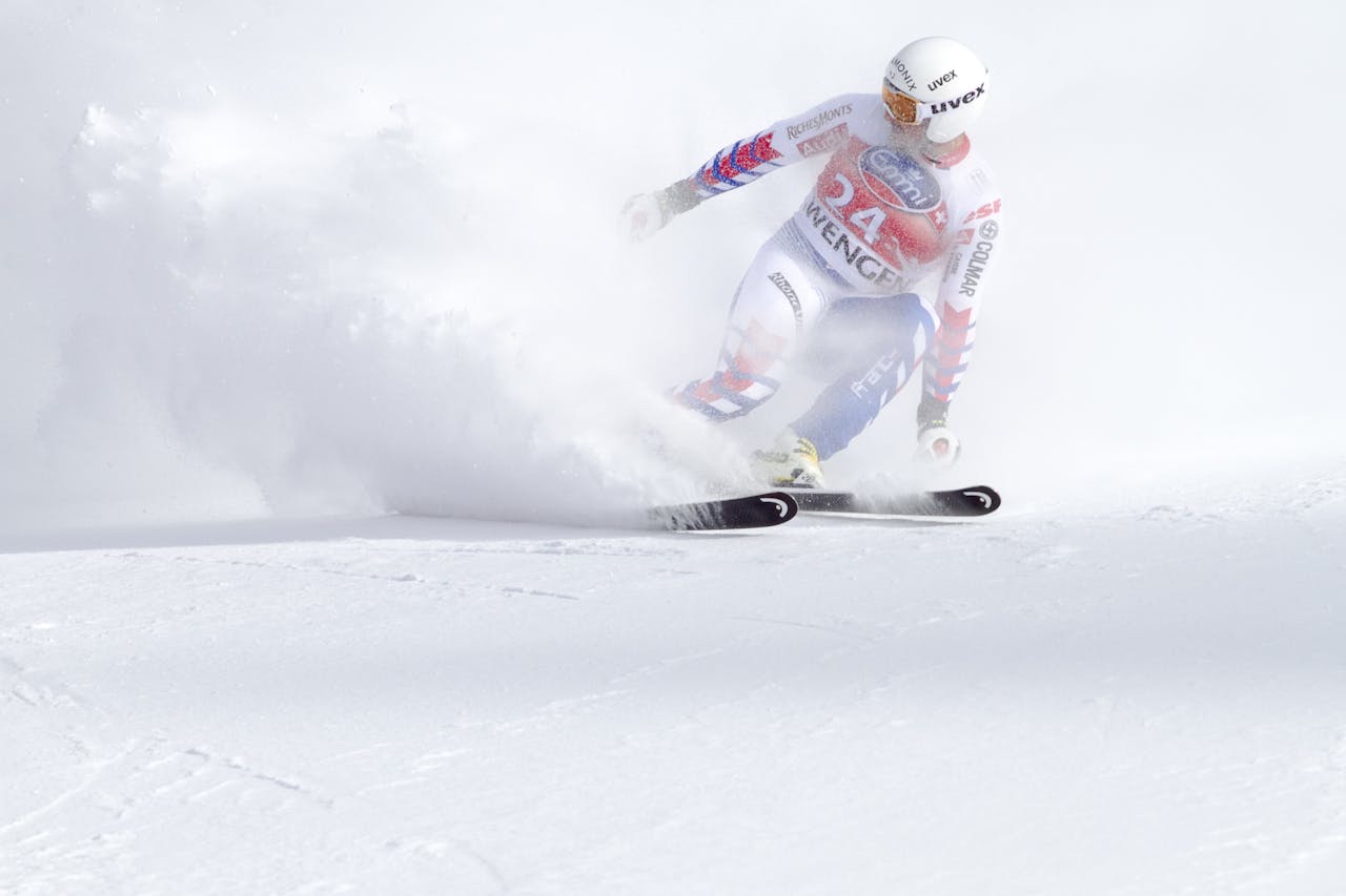 A skier in motion navigating a snowy slope with speed and precision during a winter sports event.